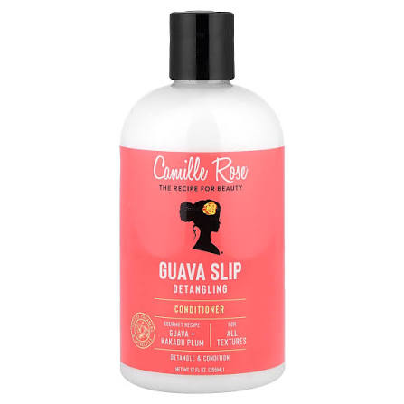 A bottle of Camille Rose Guava Slip Detangling Conditioner, featuring a white bottle with a vibrant coral-pink label and a black cap, set against a plain white background.