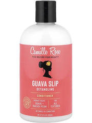 A bottle of Camille Rose Guava Slip Detangling Conditioner, featuring a white bottle with a black cap and a coral pink label.