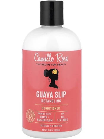 A bottle of Camille Rose Guava Slip Detangling Conditioner, featuring a white bottle with a black cap and a coral pink label.